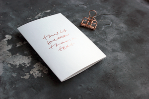 this luxury white greetings card is hand foiled with the phrase 'this is better than a text'