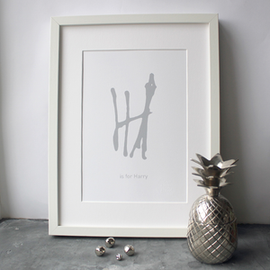 This personalised children's initial print is a unique hand drawn typography design in grey on white paper.