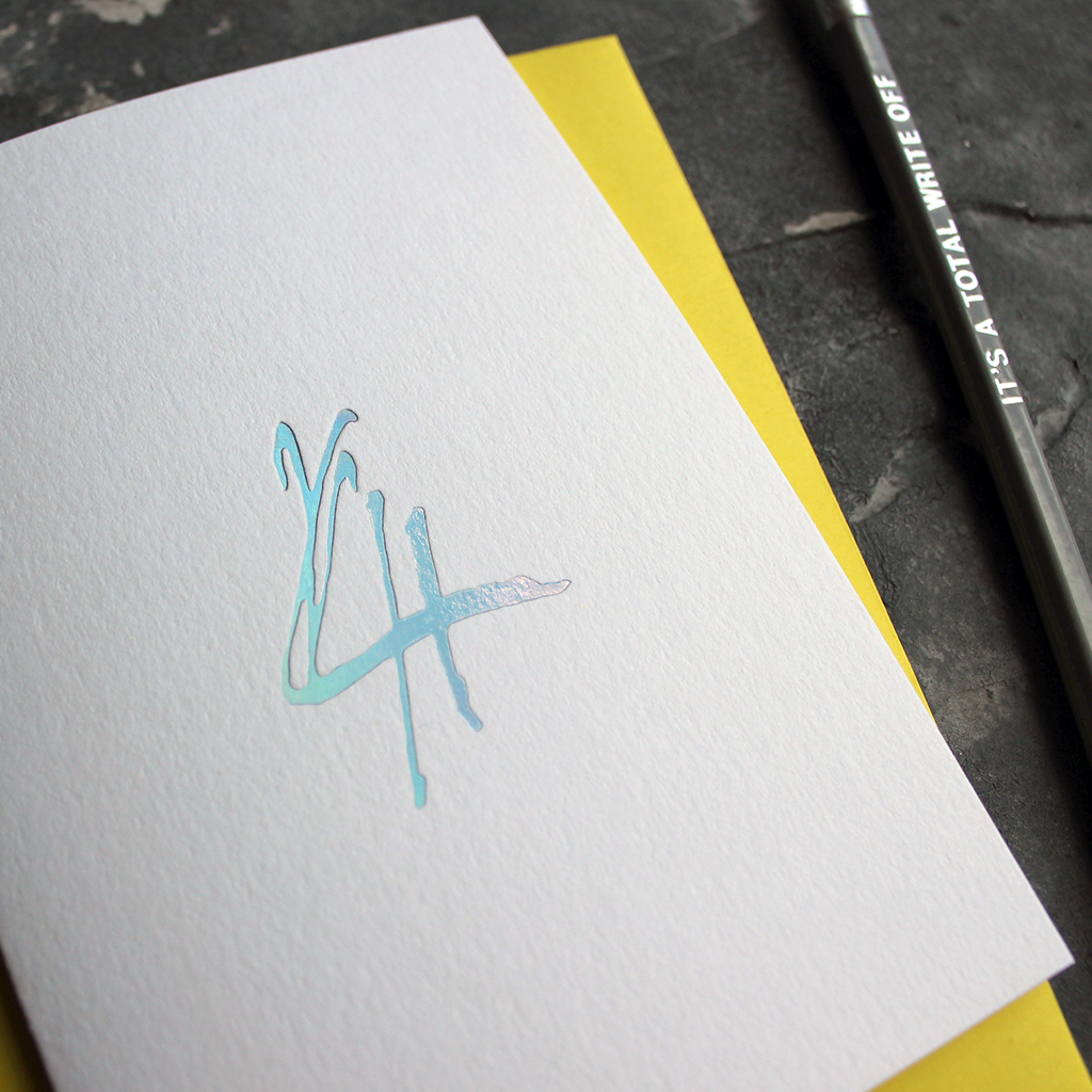 A fourth birthday card with a hand drawn number four hand pressed in holographic foil on the front
