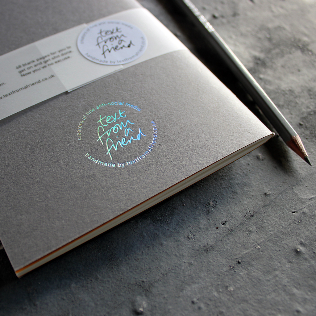 a handmade luxury notebook that's hand foiled with a holographic foil