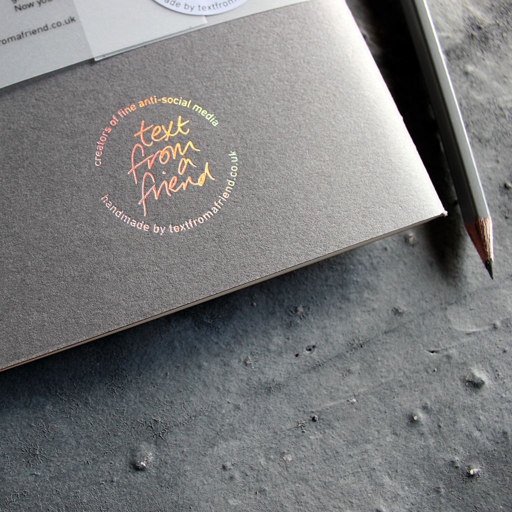 a handmade luxury notebook that's hand foiled with a holographic foil