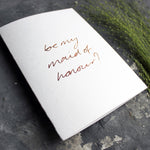 this hand foiled card asks 'be my maid of honour?' on the front in handwriting on white paper