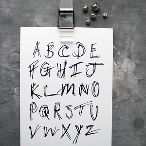This children's alphabet print is a unique hand drawn typography design in black letters on white paper.  