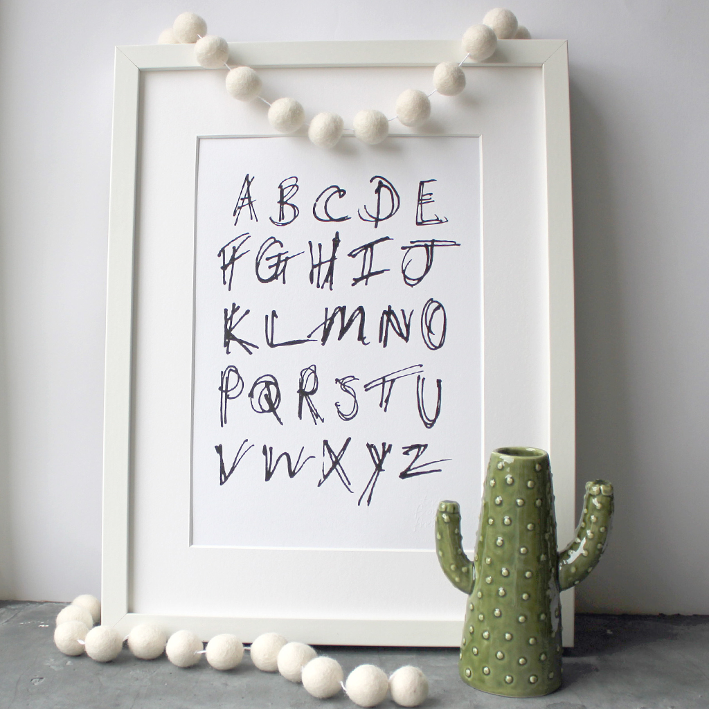 This children's alphabet print is a unique hand drawn typography design in black letters on white paper.  