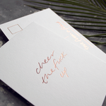 a hand pressed rose gold foil postcard that says Cheer The Fuck Up
