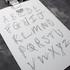 This children's alphabet print is a unique hand drawn typography design in black letters on white paper.  