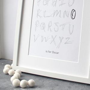 This children's personalised alphabet print is a unique hand drawn typography design in grey and black letters on white paper.