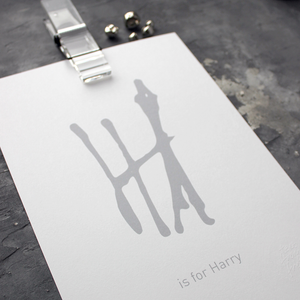 This personalised children's initial print is a unique hand drawn typography design in grey on white paper.
