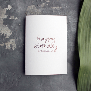 the card has happy birthday I remembered hand written in rose gold foil on the front