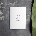 luxury handmade rose gold foil card says ho ho ho on the front