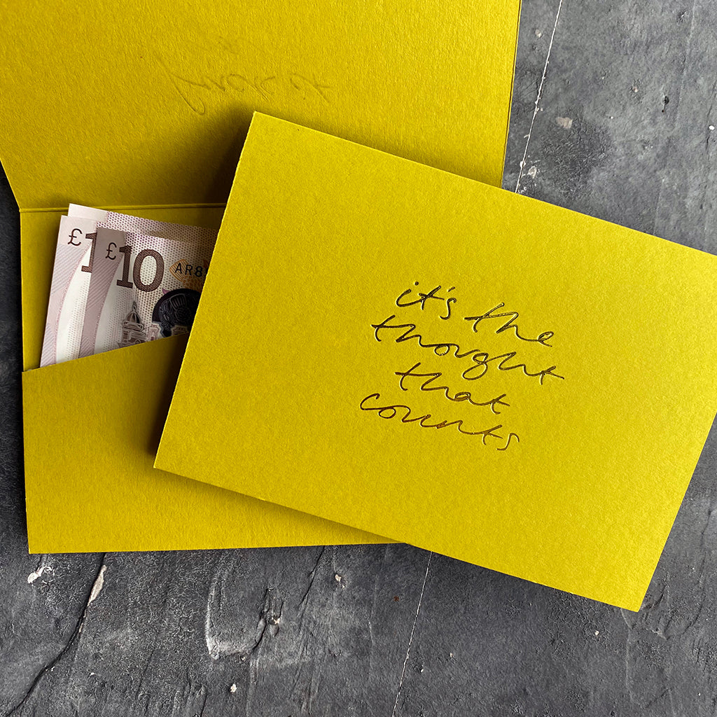this hand foiled lime coloured cash card says 'It's The Thought That Counts' on the front