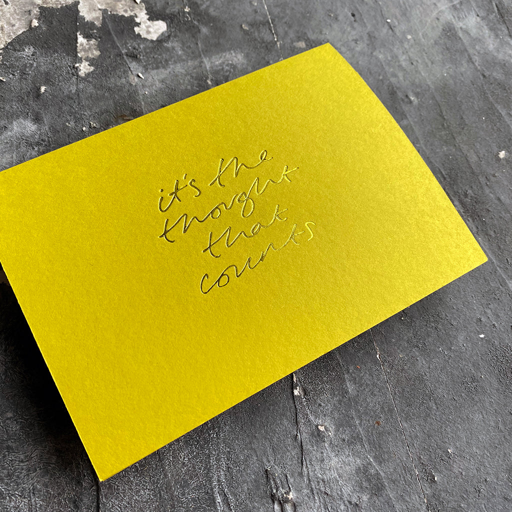 this hand foiled lime coloured cash card says 'It's The Thought That Counts' on the front