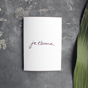 Je T'aime means I Love You in French and it's handwritten then hand foiled in rose gold on the front of this luxury card