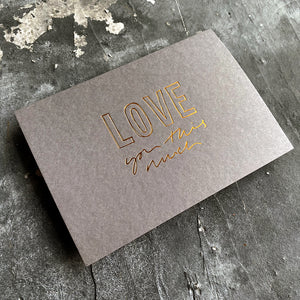 this hand foiled smoke grey coloured cash card says 'Love You This Much' on the front in bronze foil