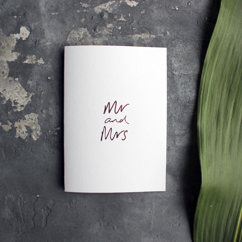 this luxury wedding card that's handwritten with a rose gold foil message saying mr and mrs