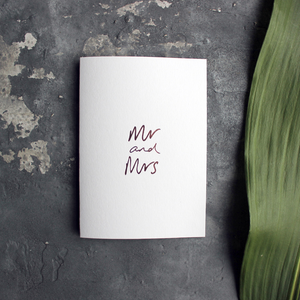 this luxury wedding card that's handwritten with a rose gold foil message saying mr and mrs