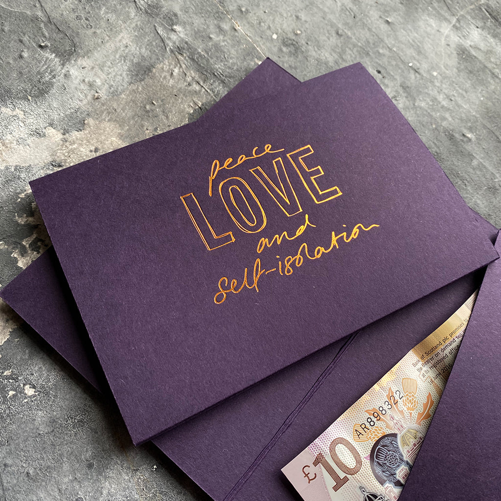this hand foiled smoke purple coloured cash card says 'Peace Love and Self-Isolation' on the front in rose gold foil