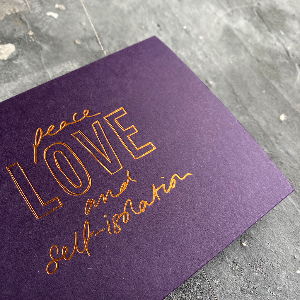 this hand foiled smoke purple coloured cash card says 'Peace Love and Self-Isolation' on the front in rose gold foil
