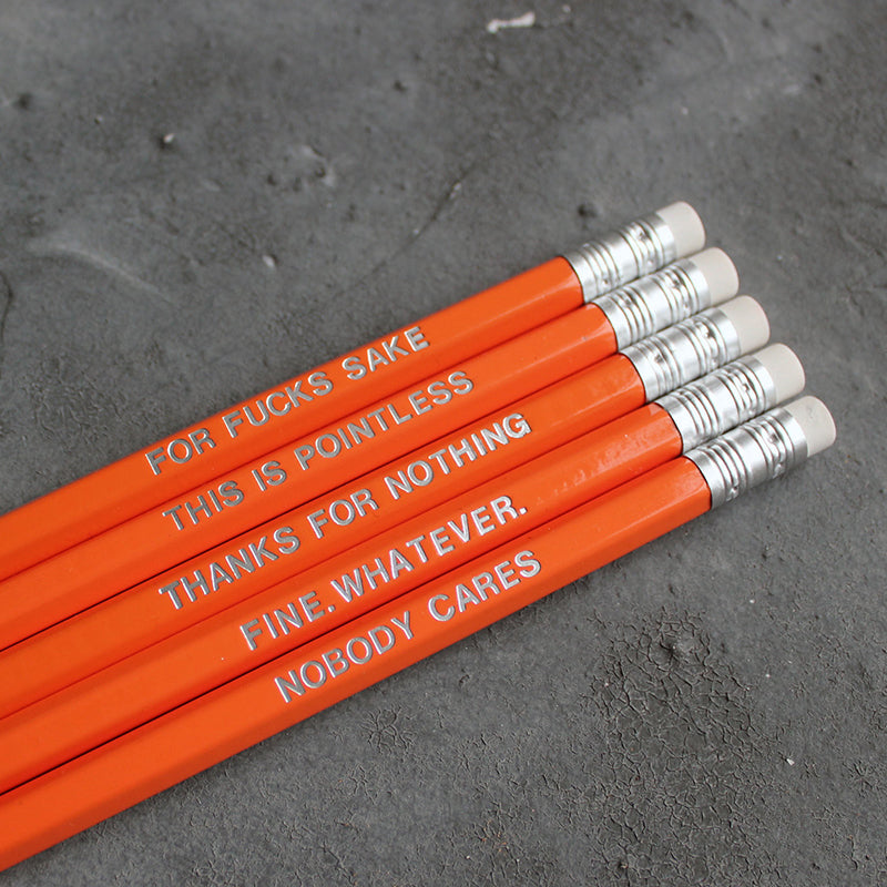 Orange HB pencils printed with silver foil phrases and packaged in a grey paper box. 