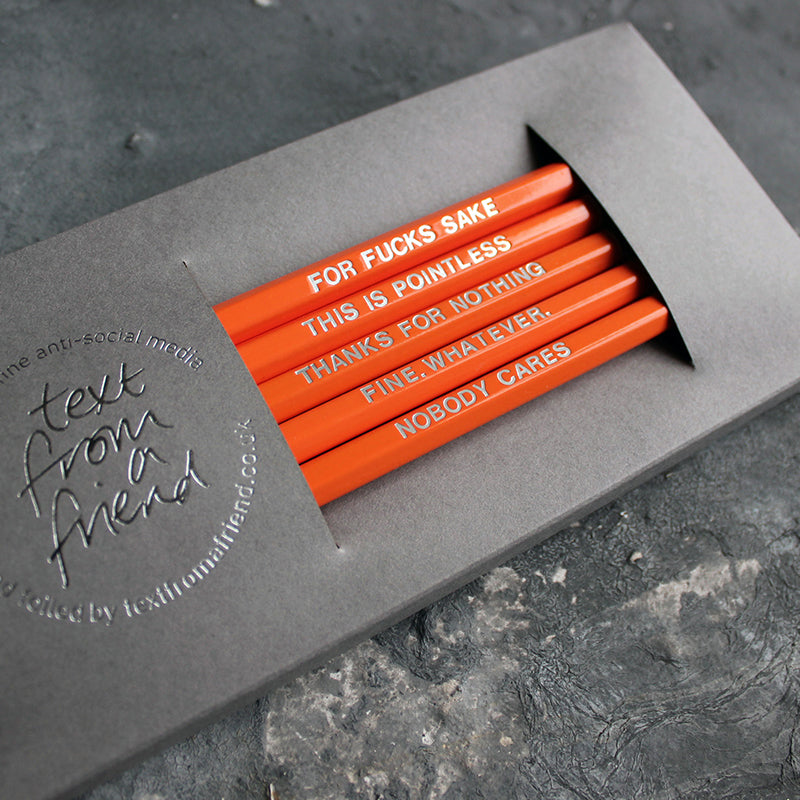 Orange HB pencils printed with silver foil phrases and packaged in a grey paper box. 