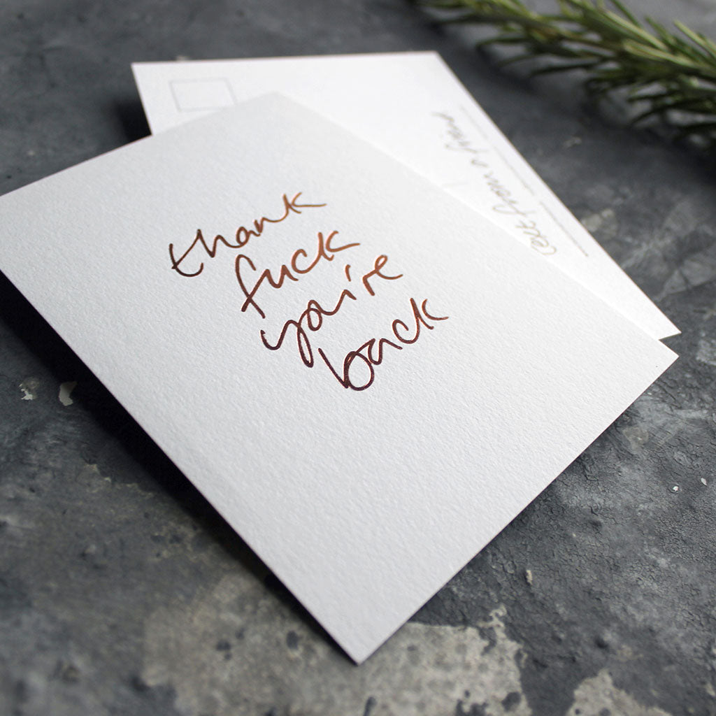 Thank Fuck You're Back postcard in rose gold foil blocking