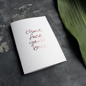 a luxury card says Thank Fuck You're Back card in Rose Gold foil on the front