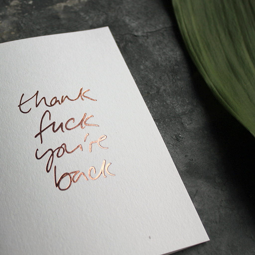 a luxury card says Thank Fuck You're Back card in Rose Gold foil on the front