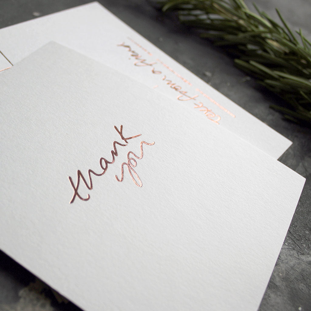 a luxury wedding card that's handwritten with a rose gold foil message saying Thank You