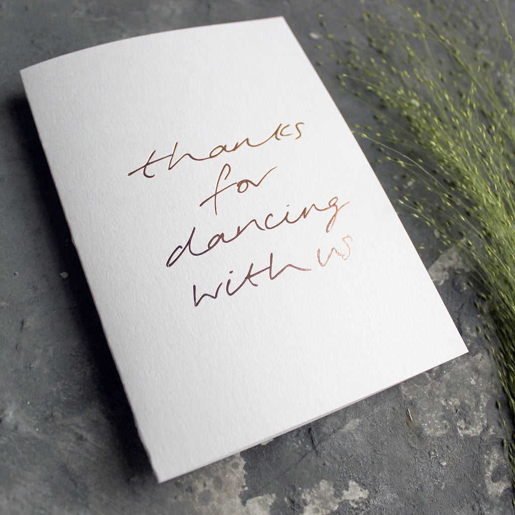 This white luxury card is hand foiled and says 'thanks for dancing with us' on the front