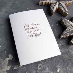 This christmas card says Tis The season to get stuffedon hand foiled on white luxury paper on grey board