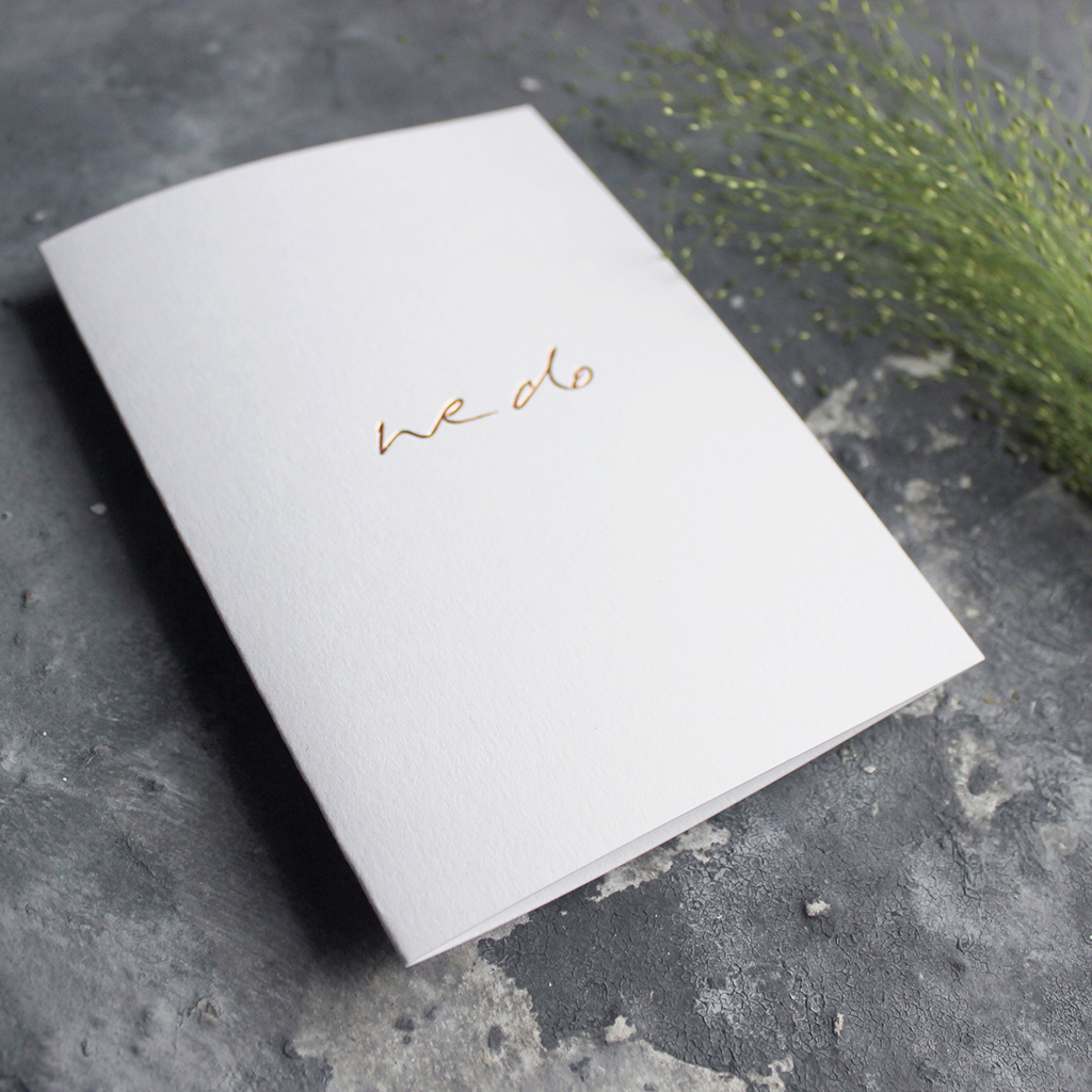 This hand foiled acceptance card says 'We Do' on white luxury paper