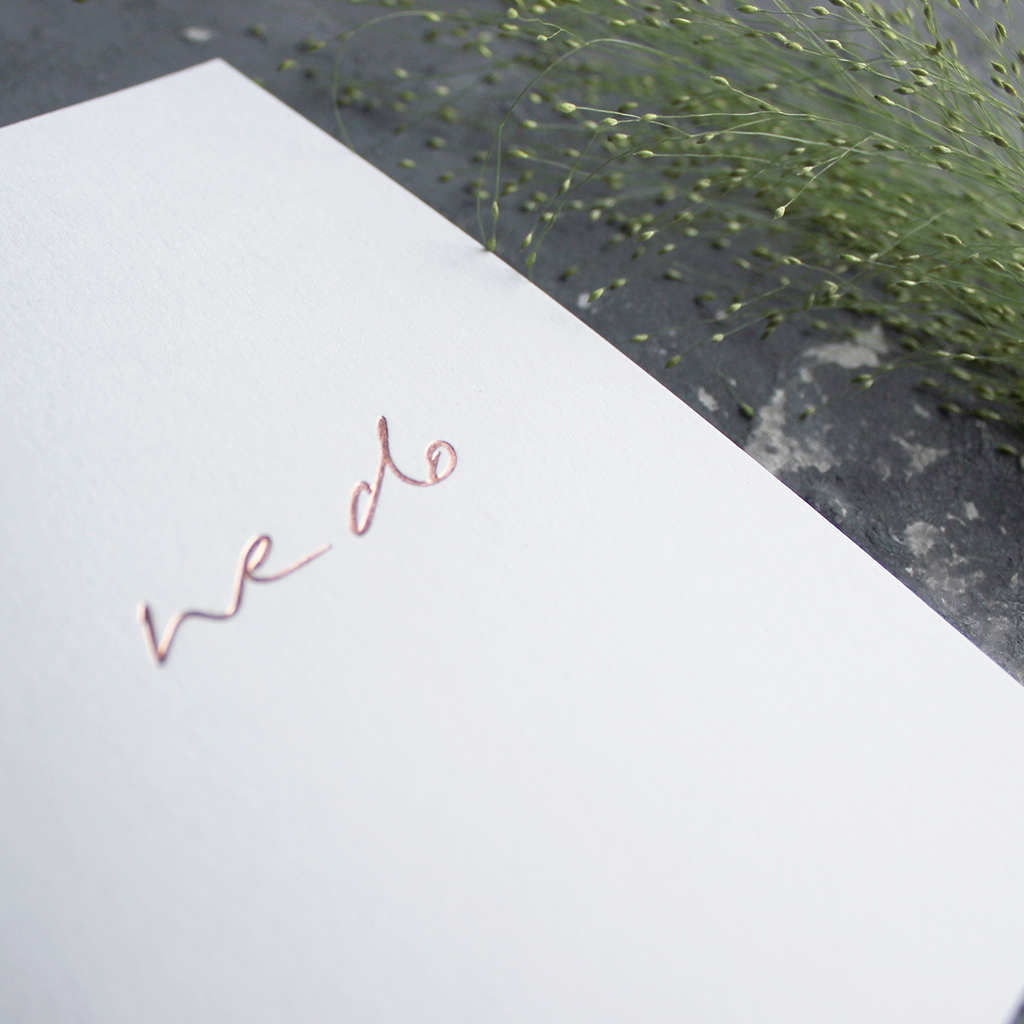 This hand foiled acceptance card says 'We Do' on white luxury paper