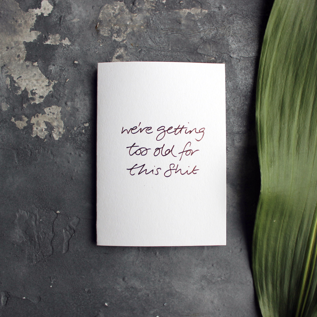 this birthday card has a handwritten rose gold foil message saying we're getting too old for this shit