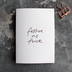 This white christmas card has 'Festive As Fuck' handprinted in rose gold foil in handwriting on the front.