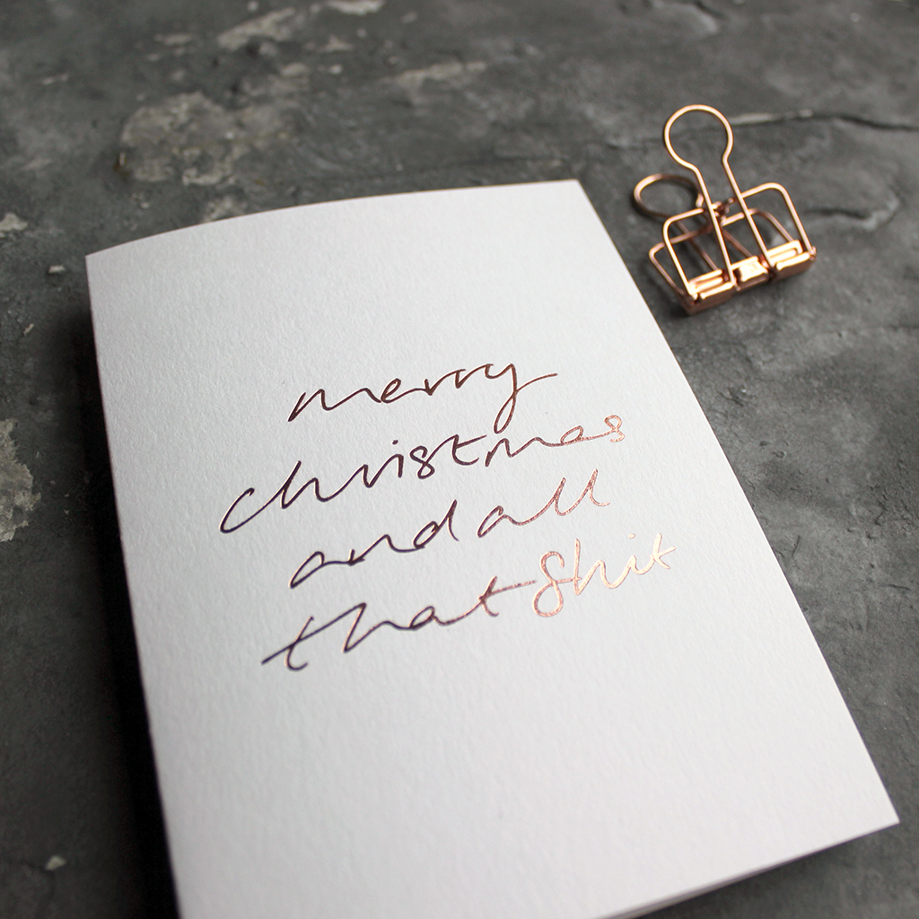 This luxury white card has a hand foiled rose gold message on the front that says Merry Christmas and all that Shit