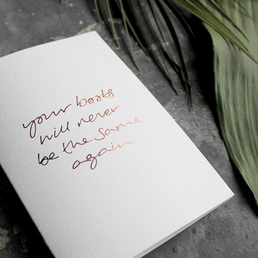 The front of the card says Your Boobs Will Never Be The Same Again hand foiled in Rose Gold