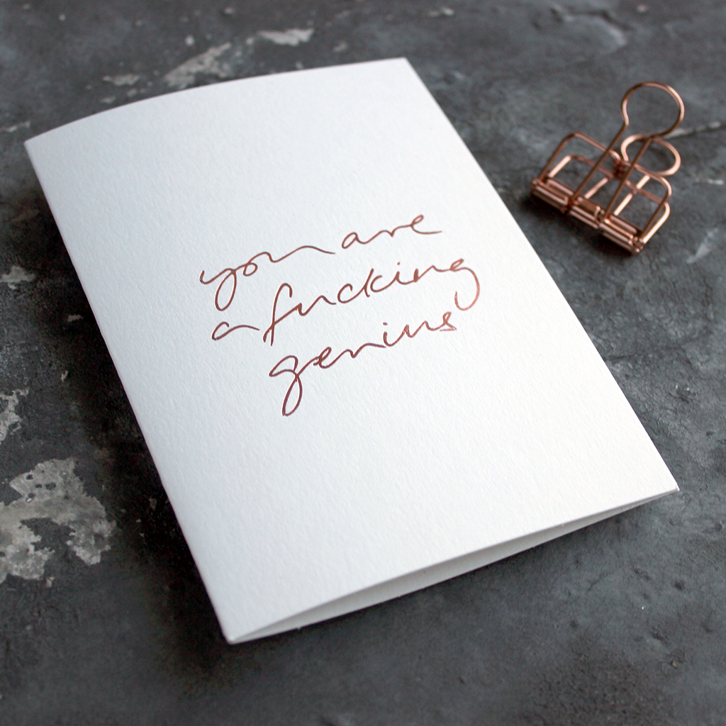 You Are A Fucking Genius is a luxury white card hand foiled in rose gold on the front