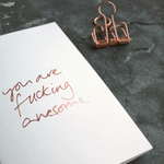 You Are Fucking Awesome is a luxury white card hand foiled in rose gold on the front