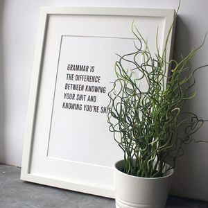 A digital print that states 'Grammar is the difference between knowing your shit and knowing you're shit' in a white frame