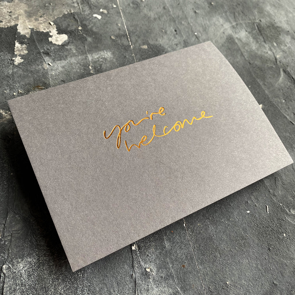 this hand foiled smoke grey coloured cash card says 'Love You This Much' on the front in bronze foil