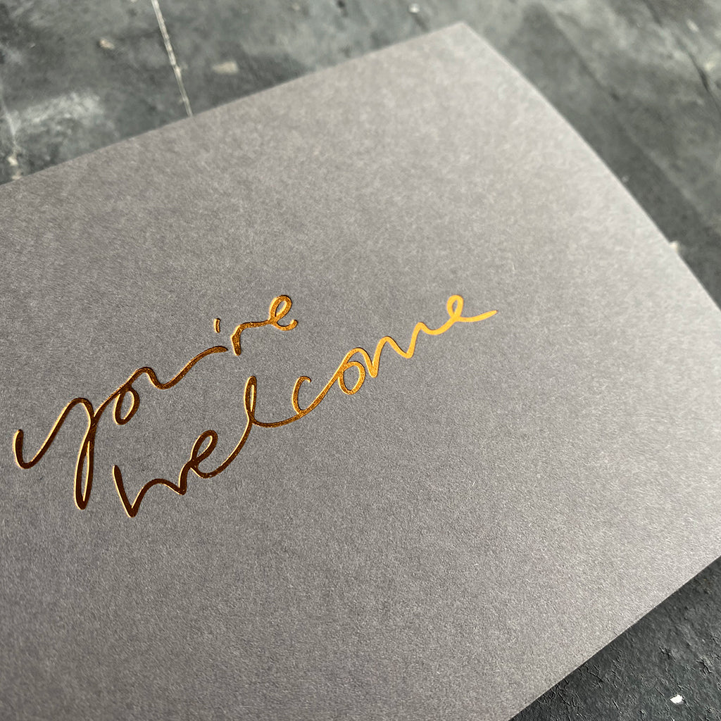 this hand foiled smoke grey coloured cash card says 'Love You This Much' on the front in bronze foil