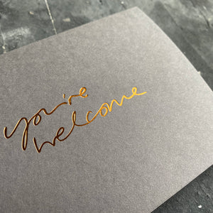 this hand foiled smoke grey coloured cash card says 'Love You This Much' on the front in bronze foil
