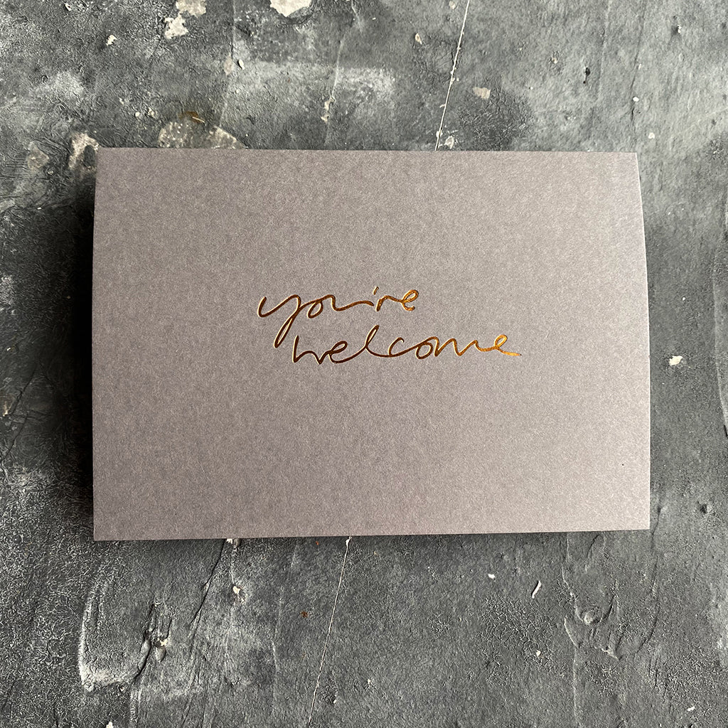 this hand foiled smoke grey coloured cash card says 'Love You This Much' on the front in bronze foil