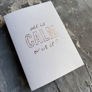This luxury Christmas Card has a hand written rose gold foil block message saying All Is Calm Or Is It? on the front