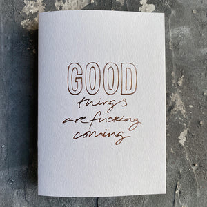 This luxury Christmas Card has a hand written rose gold foil block message saying Good Things Are Fucking Coming on the front