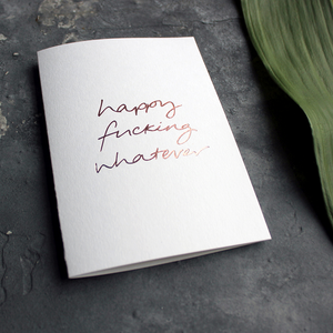 The handwritten rose gold foil message on the card says Happy Fucking Whatever