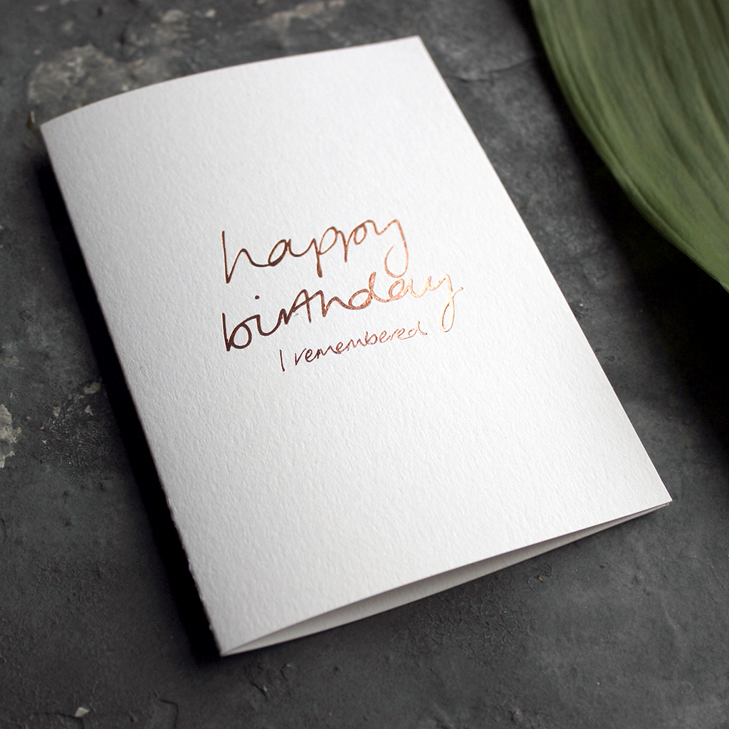 the card has happy birthday I remembered hand written in rose gold foil on the front