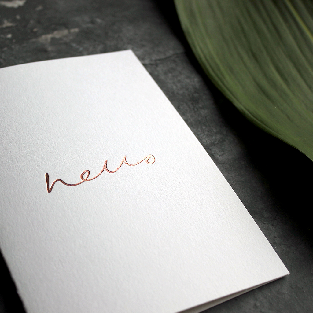 an all round card to send for any occasion that has hello hand written and foil stamped in rose gold