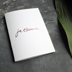 Je T'aime means I Love You in French and it's handwritten then hand foiled in rose gold on the front of this luxury card