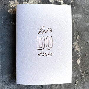 xThis luxThis luxury card has a hand written rose gold foil block message saying Let's Do This on the front